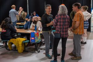 People standing around mingling during a gathering of the Southwestern PA Climbers Coalition